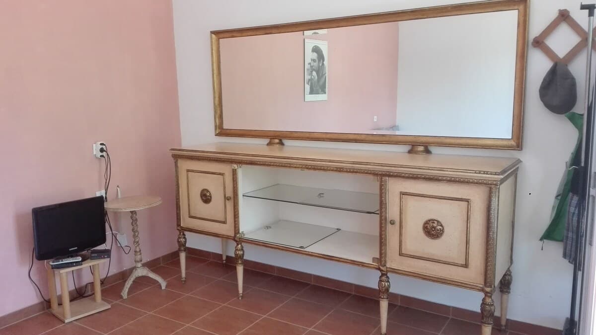 Vintage dresser with gold-framed mirror