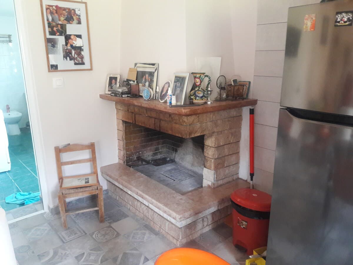 Stone fireplace with family photos on the mantle