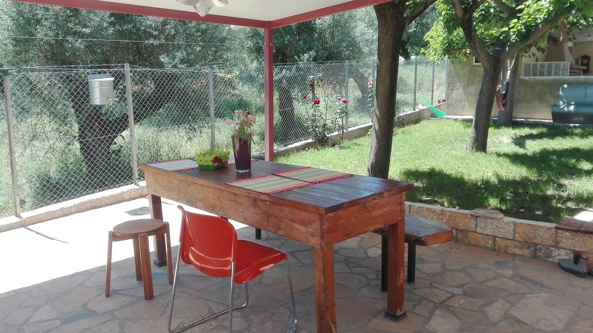 Outdoor dining table under shade with garden view
